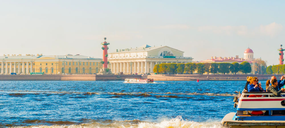 St Petersburg panorama-Neva river and Saint Petersburg landmarks of Vasilievsky island with touristic boats in St Petersburg